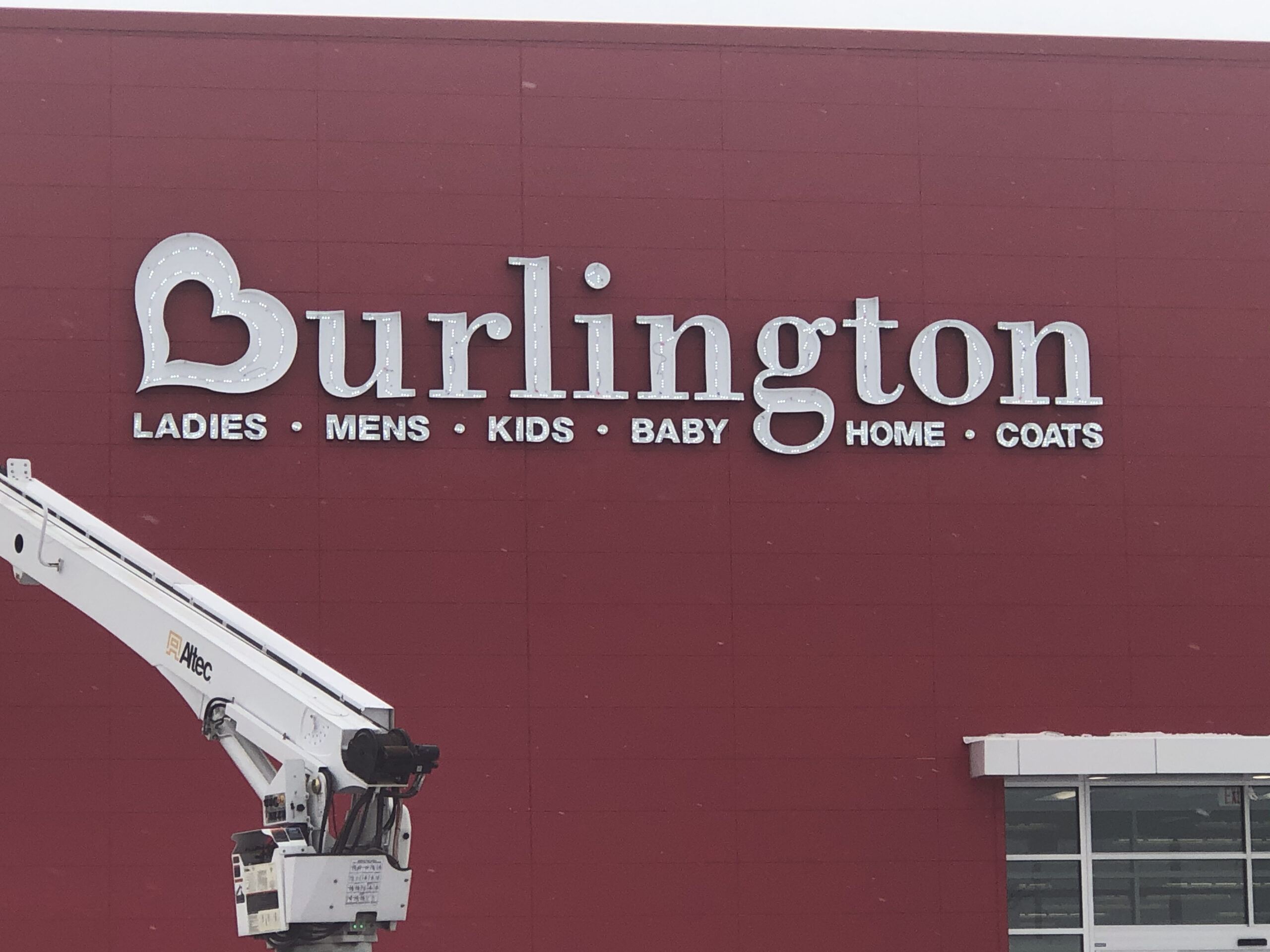A Burlington storefront with new signage being installed by Identiti.
