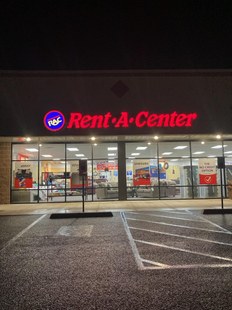 Exterior view of a Rent-A-Center location at night, with illuminated signage by Identiti.
