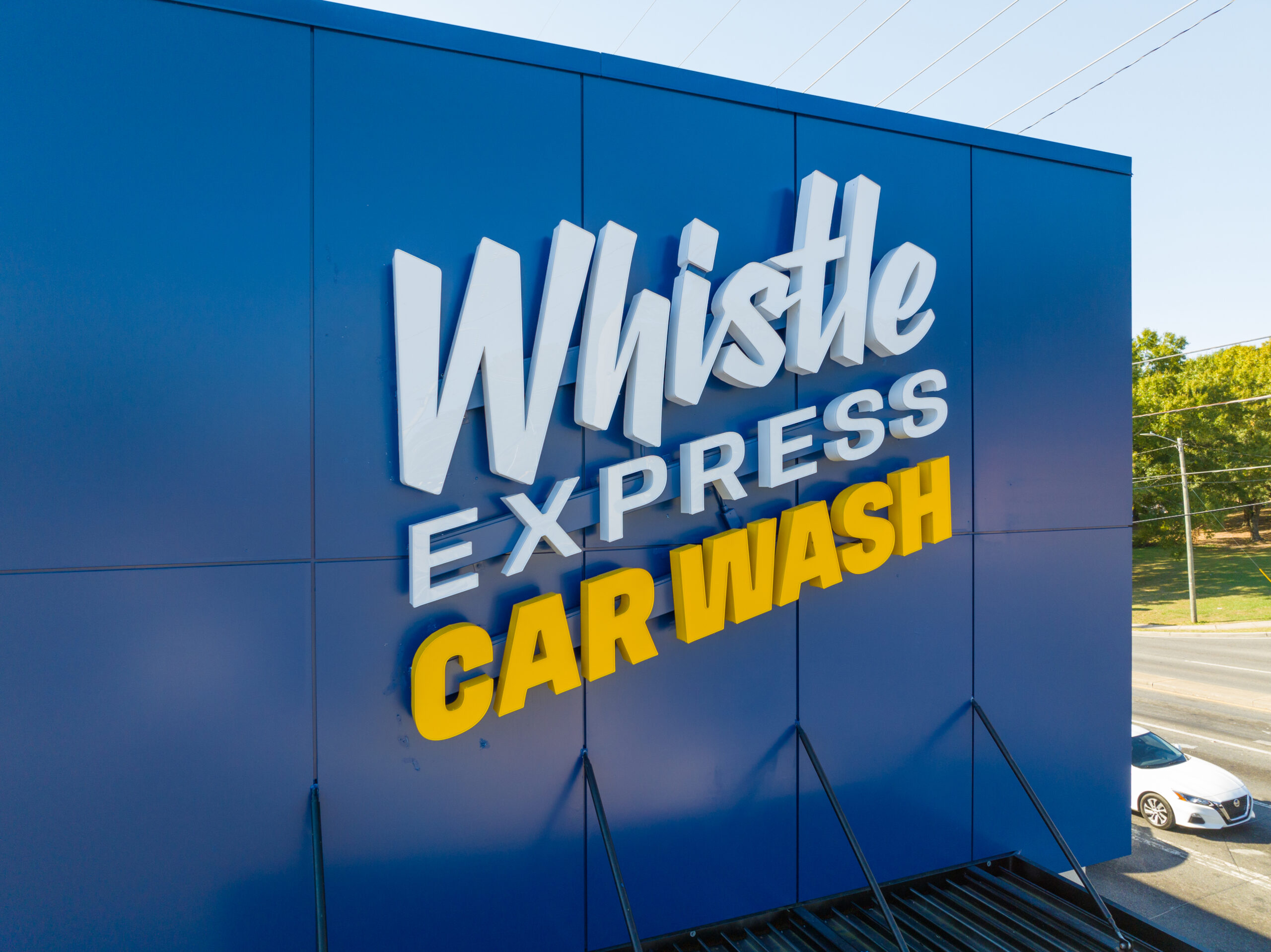 Exterior signage for Whistle Express Car Wash.
