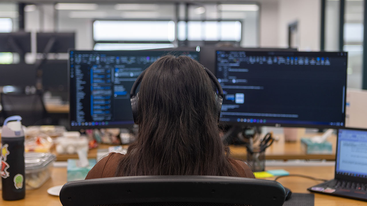 An Identiti employee paying careful attention to a computer screen.