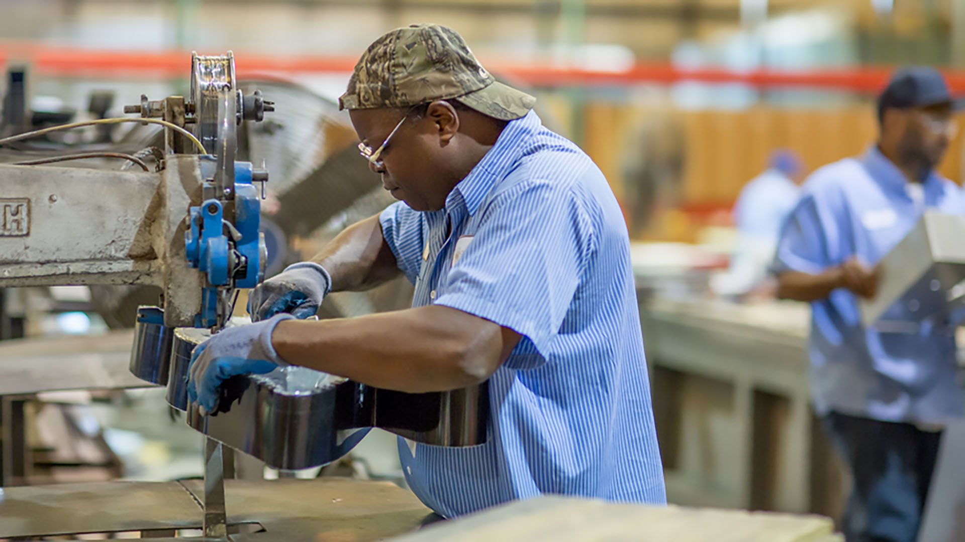 An in-house Identiti manufacturer at work using large machinery.