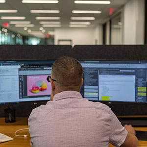An Identiti designer working carefully on a client design file.