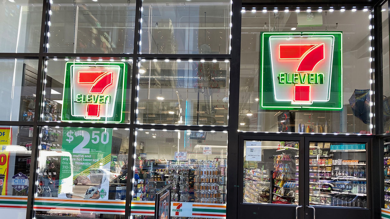 A 7-Eleven storefront featuring custom neon signage by Identiti.