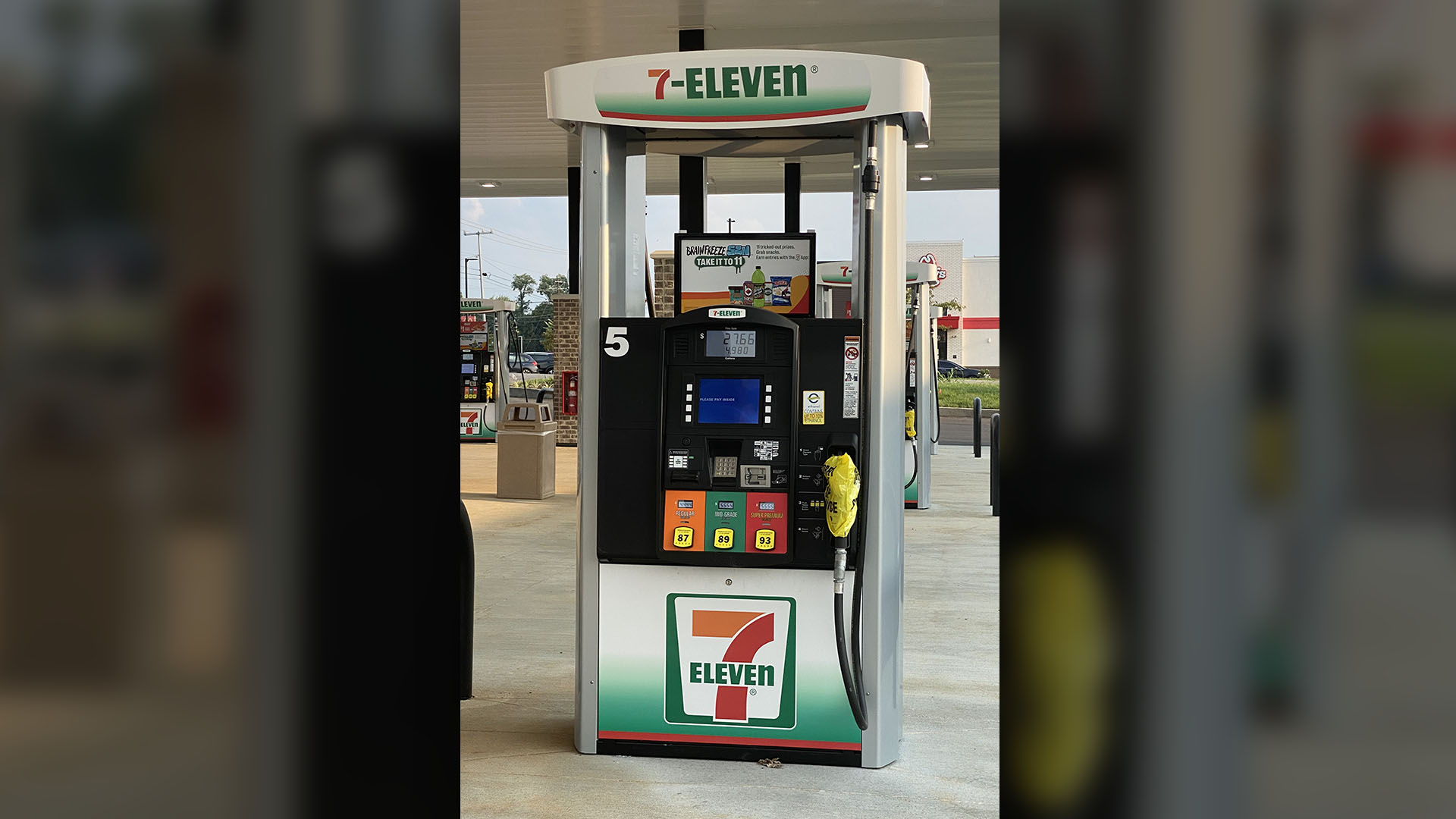 A 7-Eleven gas pump fitted with custom wrap signage by Identiti.