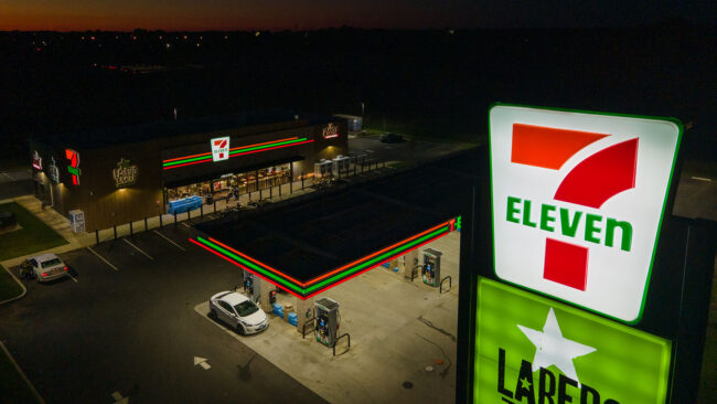 A 7-Eleven retail location from above, at night, showcasing the newly installed illuminated signage by Identiti.