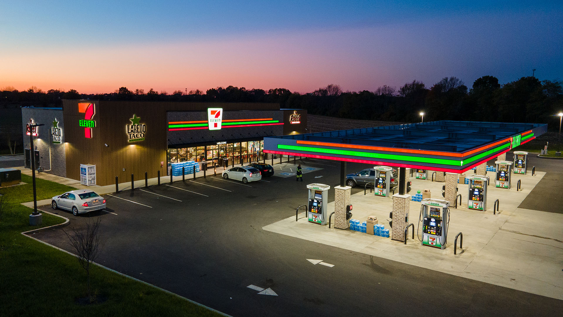 A 7-Eleven retail location at night, showing Identiti's full-scale exterior signage, fully illuminated.