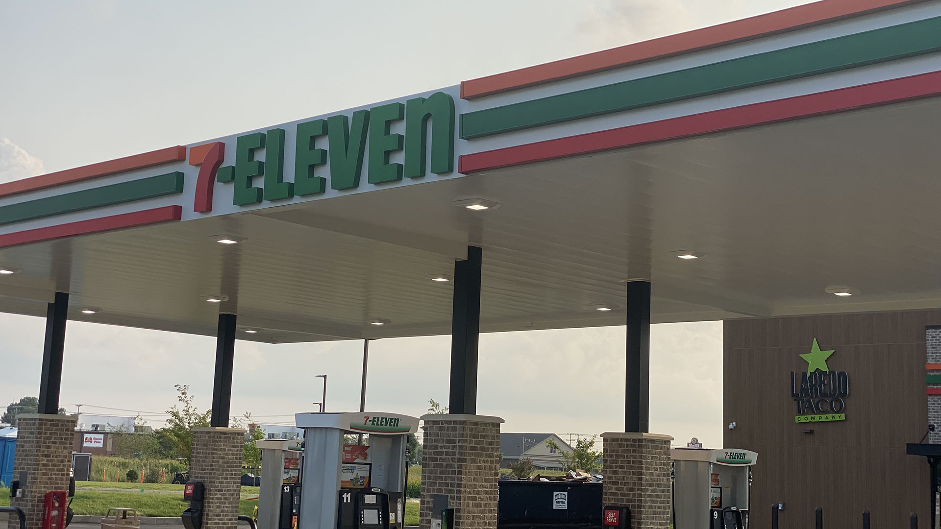 A 7-Eleven gas station canopy featuring custom exterior signage by Identiti.