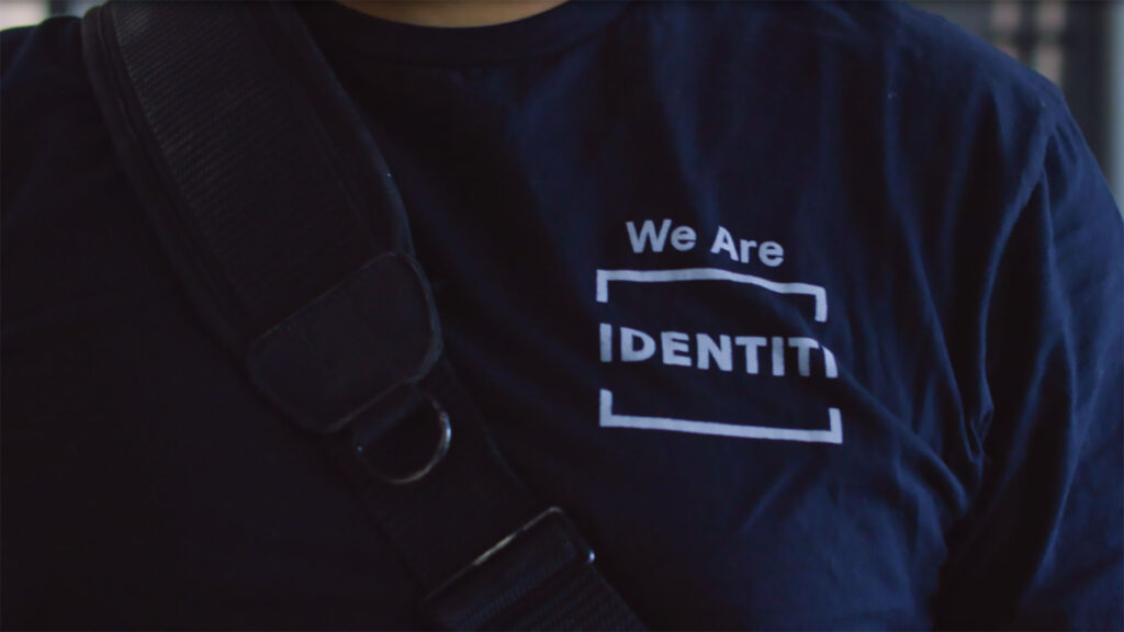 An Identiti facility maintenance professional wearing a t-shirt that says "We Are Identiti".
