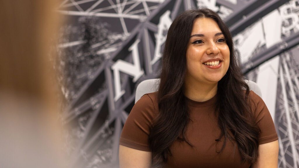 An Identiti team member smiles during a meeting.
