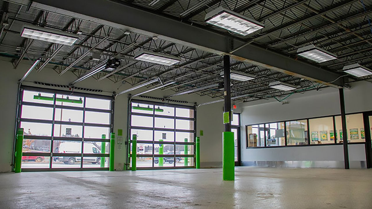 A large garage interior, featuring custom wraps and elements designed and installed by Identiti.