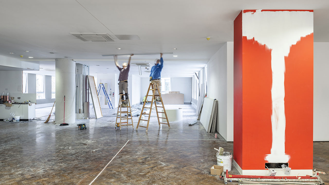 A pair of Identiti facilities providers refreshing a client's space with new interior painting.
