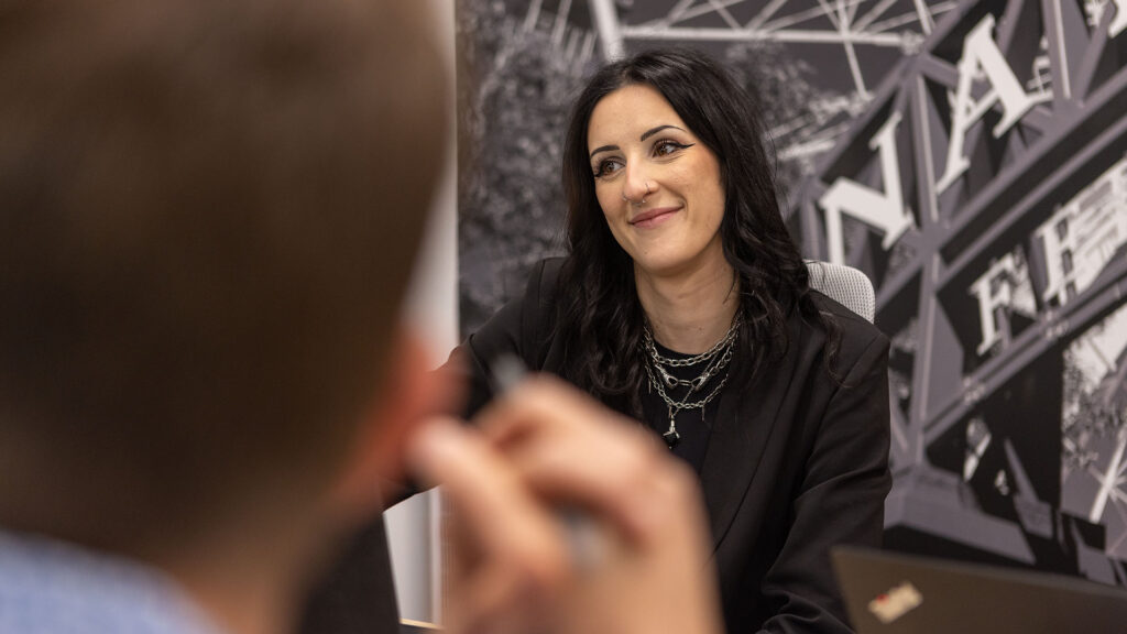 An Identiti team member smiling during a meeting.