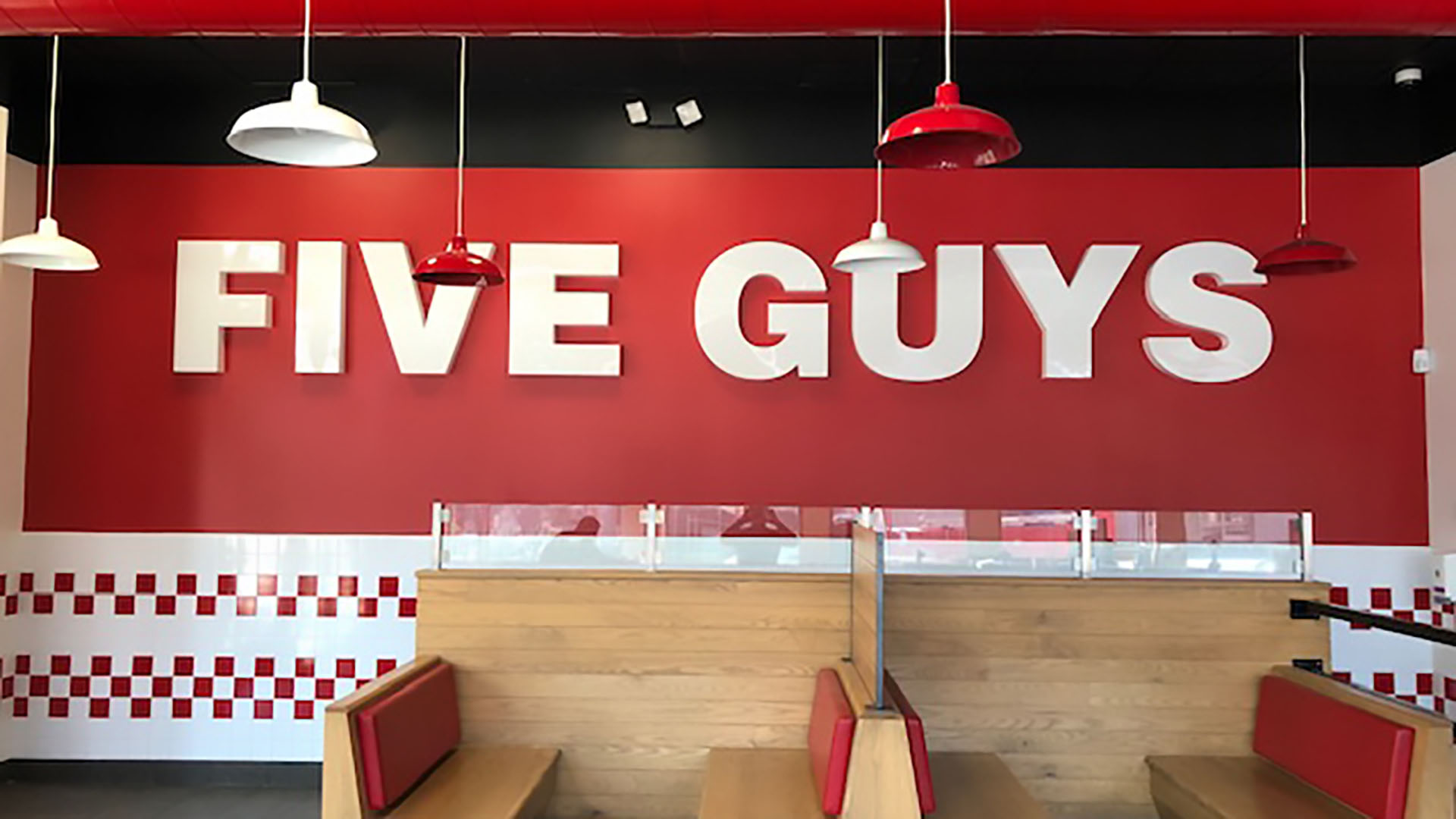 Interior branding for a Five Guys restaurant location, by Identiti.