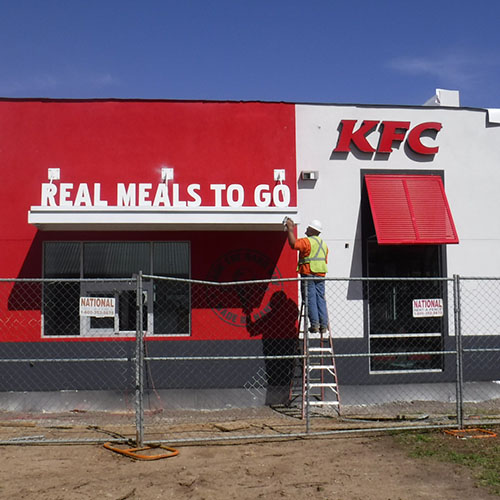 An Identiti installation partner fitting a KFC location with new exterior signage.