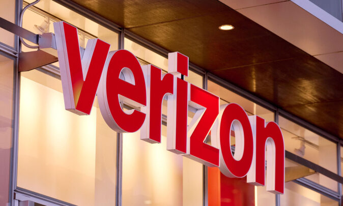 A mounted illuminated sign outside a Verizon location.