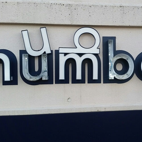 A broken exterior sign requiring immediate replacement by Identiti's field team.