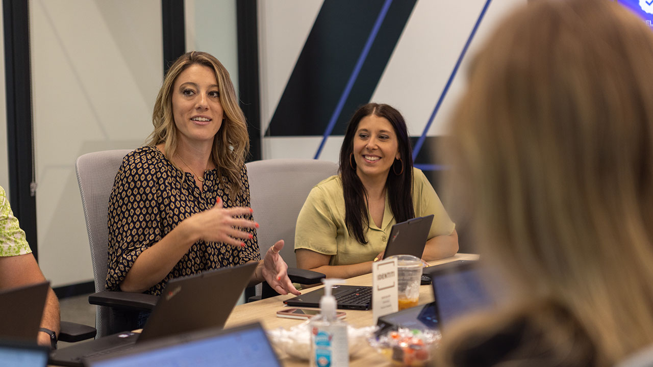 A group of Identiti team members in a conference room, smiling.