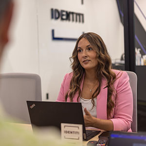 An Identiti project manager giving updates during a team meeting.